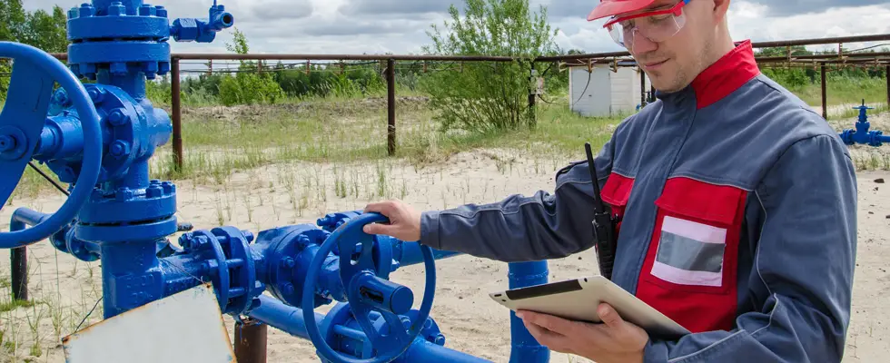 Field engineer using a SCADA interface on a tablet to review well data